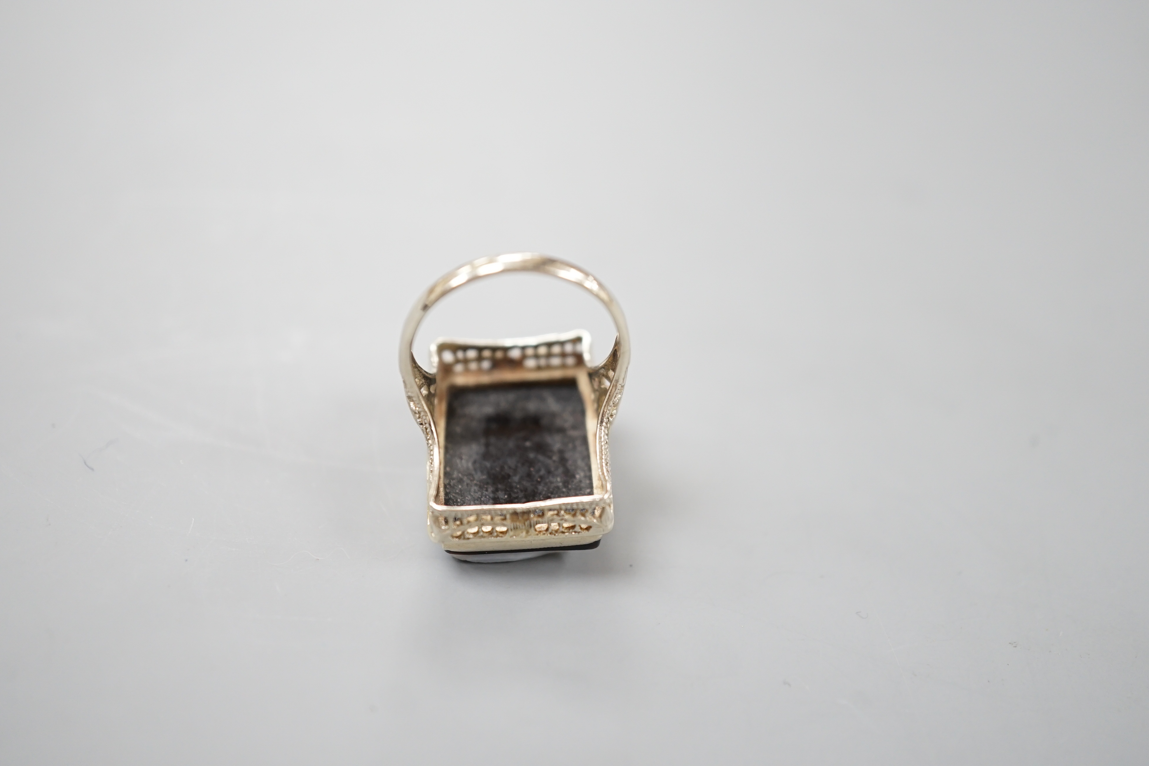 A 14k white metal and hardstone cameo set dress ring, size K/L, gross weight 5.1 grams.